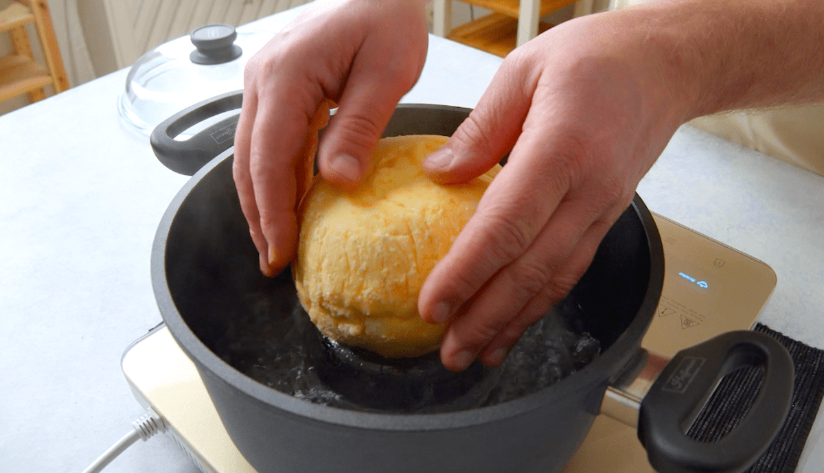 Die mit Rinderragout gefÃ¼llte Zwiebel in KloÃŸteig wird in einen Topf gesetzt