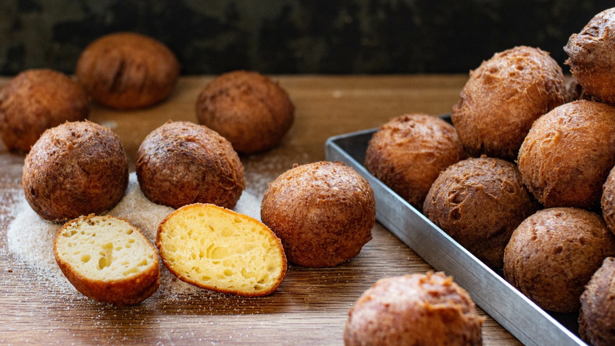 Süße Apfel-Quark-Bällchen, mit Puderzucker bestäubt.