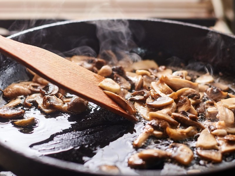 Braten ohne Fett: Ein e Pfanne, in der Champignons angebraten werden.