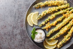 Panierter Spargel mit Panko und Parmesan auf einem Teller.