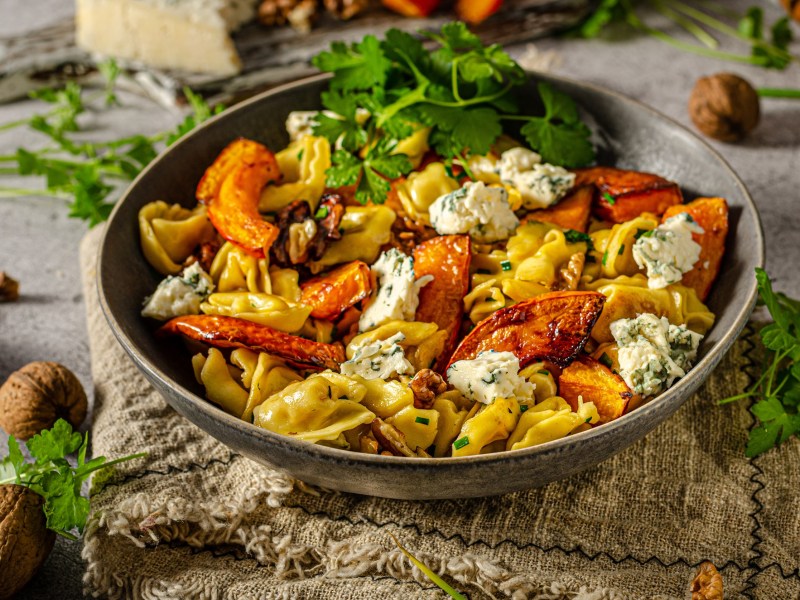 Ein Teller Tortellini mit Kürbis und Blauschimmelkäse.